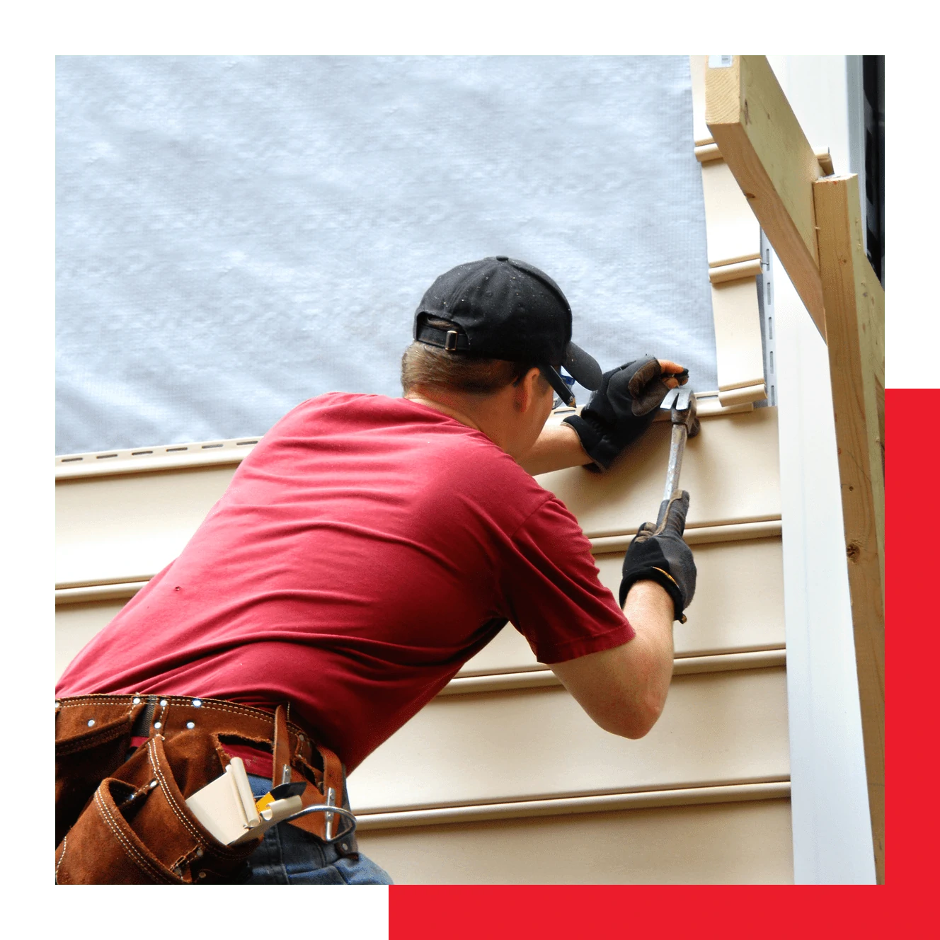 A Worker Installs Siding On The House